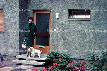 Woman and her Poodle, door, steps, flowers, wall, doorway, purse, dress suit, 1950s