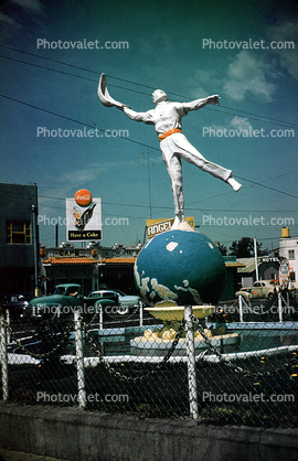 Jai Alai statue, earth globe, man, water fountain, Tijuana, August 1954, 1950s