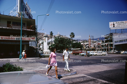 Woman and Man walking across the street, crosswalk, 1950s