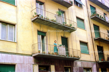 Woman standing on a balcony, May 1961