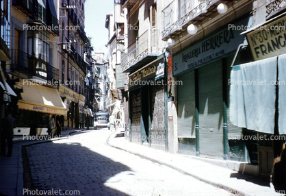 Cobblestone Street, sidewalk, buildings, shops, narrow street, 1940s