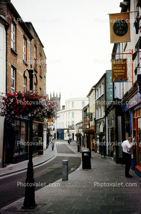 Narrow Street, cobblestone sidewalk, Buildings, shops, hanging flower pot, Ennis