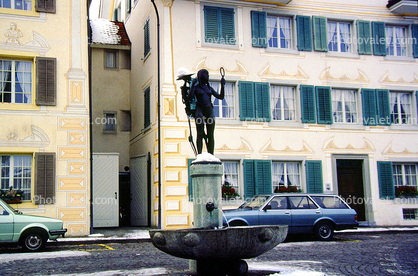 Female Statue, Water Fountain, aquatics, Building, Homes, Cars, Street, Switzerland
