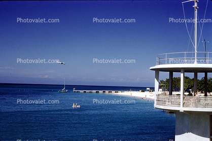 Plane landing over the beach, coast, coastline, lookout tower