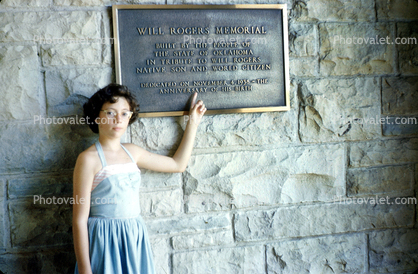brass plaque, girl, woman, brick, landmark, Will Rogers Memorial, pointing, building, August 1952, 1950s