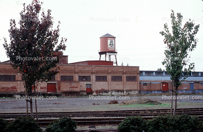 water tower, building, railroad tracks