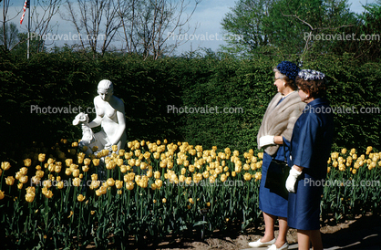 Gardens, flowers, path, people, statue, women, tulips, fur coat, shawl, hats, gloves, 1940s