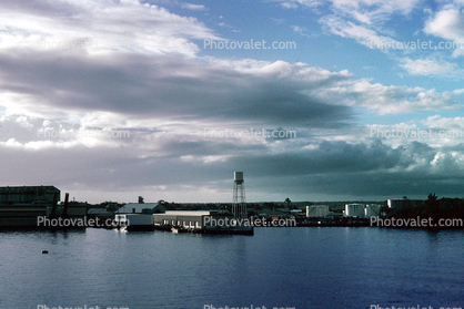 Clouds, docks, buildings, water tower