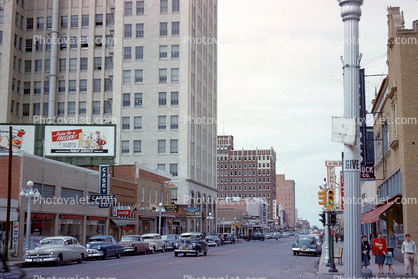 Buildings, cars, stores, street, 1950s