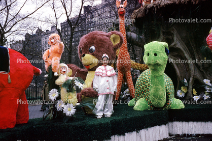 Clown with a cavalcade of animals, giraffe, turtle, bear, monkey, daisies