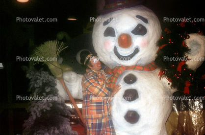 Snowman being kissed by a clown, smiles, broom, smiley face, red nose, buttons