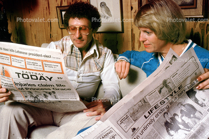 Man and Woman Reading the Oakland Tribune Newpaper