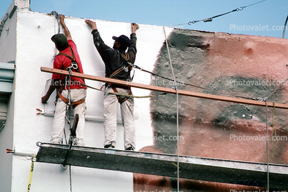 Workers putting up a billboard