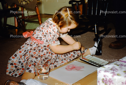 Little Girl Paints with Watercolor, Brush, Paper, Water Glass
