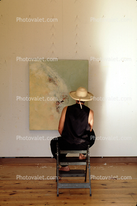 Woman Sitting, hat, veiwing artwork