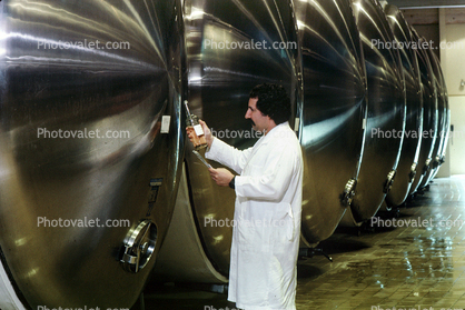 Vintner checking sugar content, Fermentation Tanks, Aluminum, Aluminum Aging barrels, Metal, Aluminum Barrels, Fermenting