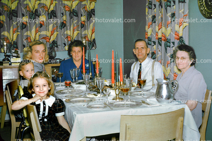 Dinner, woman, man, table setting, plates, candles, girl, boy, curtains, 1940s