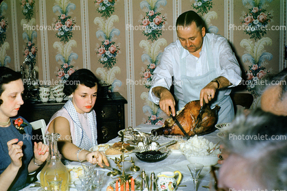 Thanksgiving Dinner, woman, man, cutting, slicing the turkey, 1940s