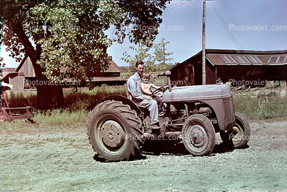 Man and Boy on Tractor, 1950s