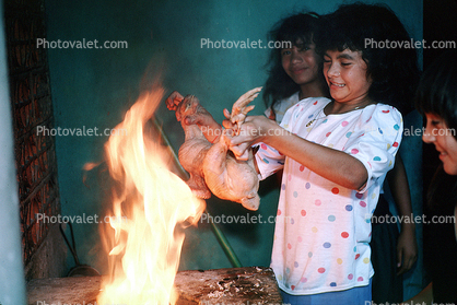 Girl Roasting a chicken, Chicken Slaughterhouse, San Salvador, El Salvador