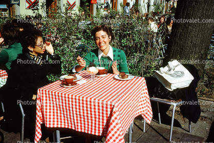 Table, Woman, Smiles, Checkerboard Tablecloth, Exterior, Outside, Outdoors, March 1975