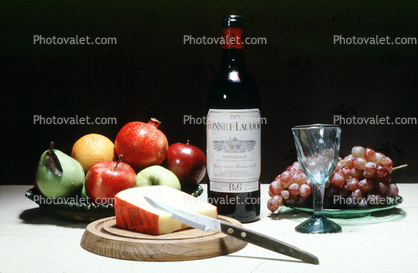 WineBottle, empty glass, Cheese, Pomegranate, grape, pear, apple, knife, fruit bowl