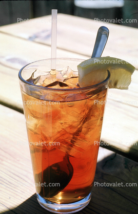 Iced Tea in a Glass, Ice, straw, lemon wedge, spoon, ice, utensil