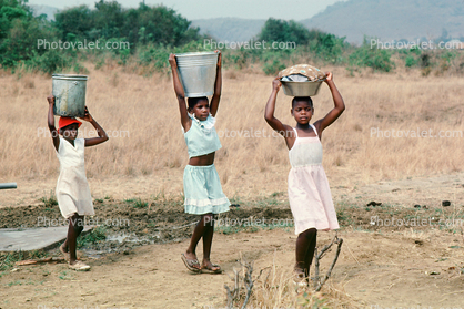 Girls Carrying water back to the village