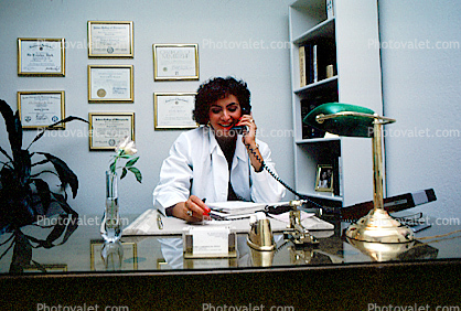 Female Doctor at her desk on the phone