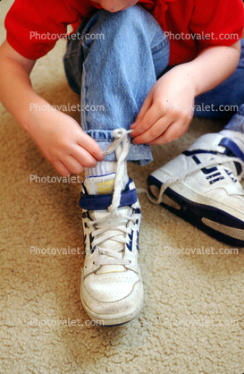 Boy Tying his shoes, shoestring