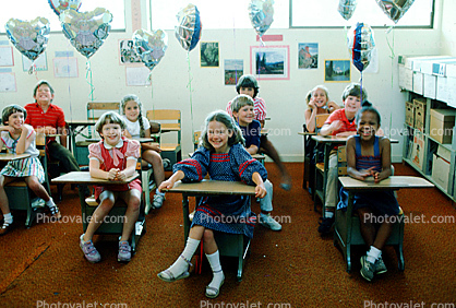 Students in a classroom, desks, class, girls, boys, smiles, smiling