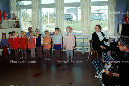 Singing, Piano, bus, windows, Russian kids in School, Moscow, Russia, 1969, 1960s