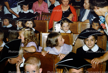 Elementary Schoolchildren, cap and gown, graduation, boys, girls, smiles, 1950s