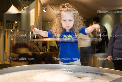 Girl playing with Bubbles, hands-on exhibit, touch