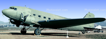 A C-47 at rest on the ground,,,,,,,,,,,,,j