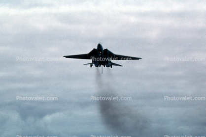 Grumman F-14 Tomcat with tailhook, landing, exhaust smoke, pollution