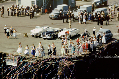 Wives greeting their husbands back home, cars, trucks, celebraton, 1940s