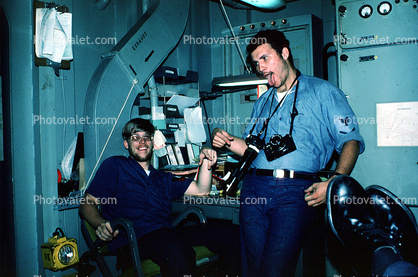 Goofing sailors onboard ship, cameras, funny, October 1976