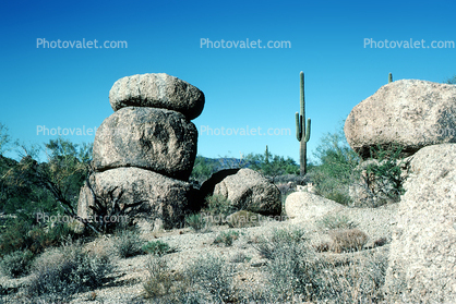 rock outcropping, cactus, stacked boulders, butte