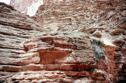 cliffs frozen with ice, layers, sandstone, schist, strata