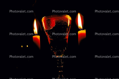 two candles and a glass