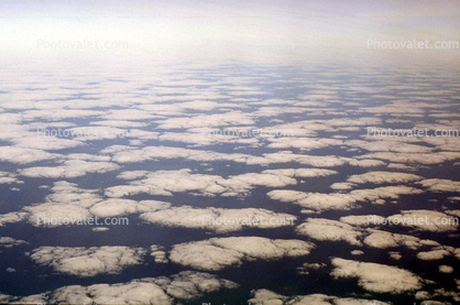 Pancakes floating in the sky, flying over the midwest USA during the winter, daytime, daylight