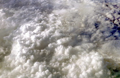 Cushiony fluffy clouds, flying over the midwest USA during the winter, daytime, daylight