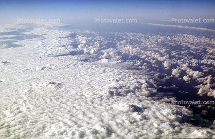 flying over the midwest USA during the winter, daytime, daylight, cumulus puffs