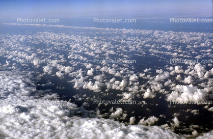 flying over the midwest USA during the winter, daytime, daylight, cumulus puffs
