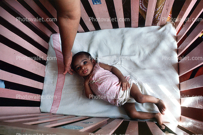 Girl in a crib, newborn