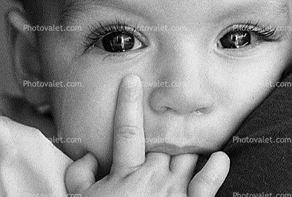 the tears in the eye, face, nose, hand, fingers, child