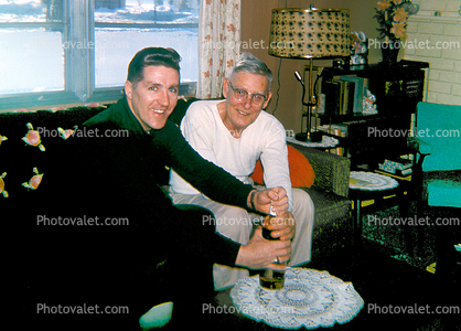 two men opening a bottle of chamagne, 1960s