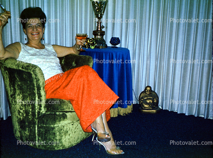Smiling Lady, beehive hairdo, smoking, chair, higheels, dress, drapes, Buddha, 1960s