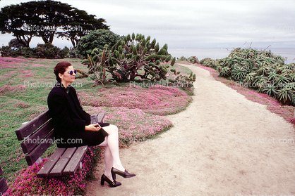 Woman sitting on a bench, Path, Pacific Grove, California